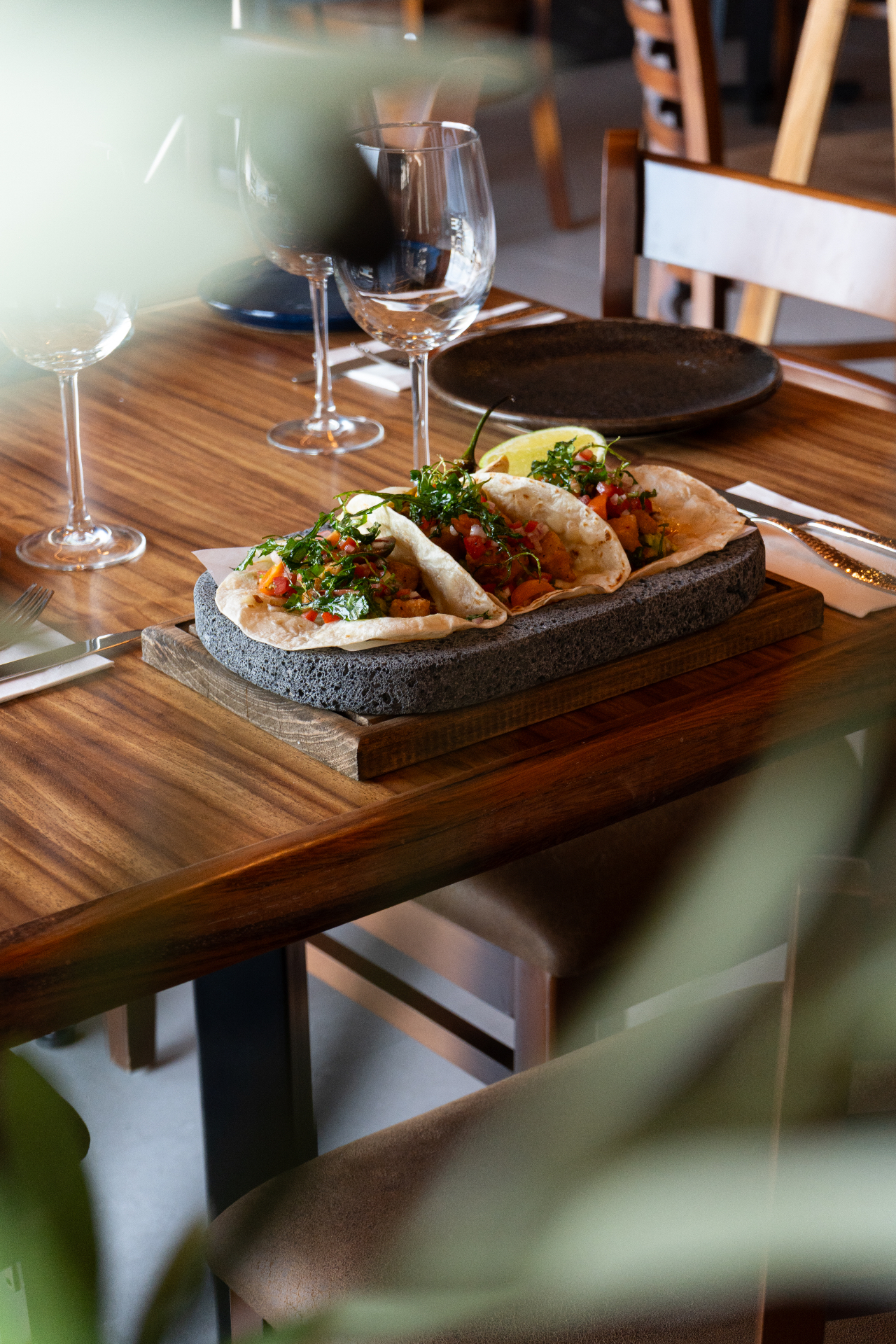Tacos en piedra volcánica servidos en mesa de Entrecot Asador